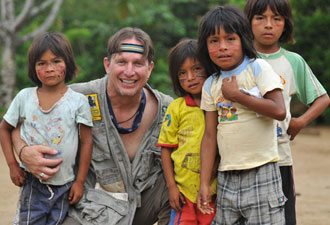 Dean Jacobs posing with children from the Amazon rain forest