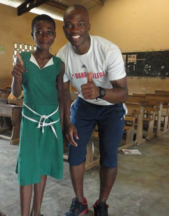 Two young African students giving a thumbs up sign