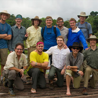 Dean Jacobs posing with fraternity students in Ecuador