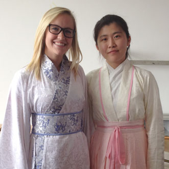 Two students dressed in kimonos smiling