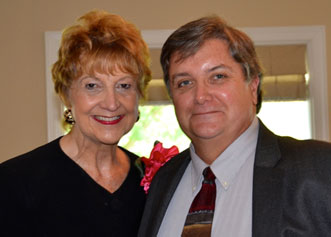 Two people smiling standing side by side