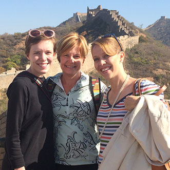 Three women standing together at the Great Wall
